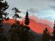 Scenic view of a mountain range at sunset, framed by lush evergreen trees at 378 Juniata Cir, Breckenridge, CO 80424