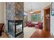 Cozy sitting room with stone fireplace, comfortable seating, and natural light at 378 Juniata Cir, Breckenridge, CO 80424