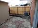 Backyard patio with a wooden fence, and exterior of a brick home at 1165 Milky Way, Thornton, CO 80260