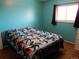 Bedroom featuring turquoise walls, carpet floors, and a window that provides plenty of natural light at 1165 Milky Way, Thornton, CO 80260