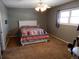 Cozy bedroom with a comfortable bed, ceiling fan, and natural light from the large window at 1165 Milky Way, Thornton, CO 80260