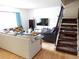 Comfortable living room with stairs, television, and a comfortable sofa at 1165 Milky Way, Thornton, CO 80260