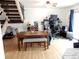 Open-concept living space featuring a staircase, dining table, and desk area, providing versatility at 1165 Milky Way, Thornton, CO 80260