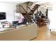 Spacious living area with staircase, hardwood floors, seating, and entertainment area, designed for comfort at 1165 Milky Way, Thornton, CO 80260