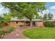 Spacious backyard with mature trees, a covered patio, and a manicured lawn at 40 S 34Th St, Boulder, CO 80305