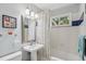 Bathroom features tub and shower combo, pedestal sink, and framed mirror at 40 S 34Th St, Boulder, CO 80305