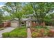 Charming two-story home with a brick pathway, lush landscaping, and mature trees at 40 S 34Th St, Boulder, CO 80305