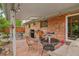 Covered brick patio with table, chairs, grill, and view of the backyard at 40 S 34Th St, Boulder, CO 80305