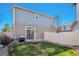A spacious backyard with a patch of grass and patio area, perfect for outdoor activities at 20017 E 48Th Pl, Denver, CO 80249