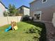 Spacious backyard with a privacy fence, patio area, and room for outdoor activities at 20017 E 48Th Pl, Denver, CO 80249