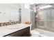 Modern bathroom with glass shower, tiled walls, and stylish vanity at 20017 E 48Th Pl, Denver, CO 80249