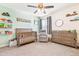 Charming bedroom with neutral color scheme, crib, and matching furniture at 20017 E 48Th Pl, Denver, CO 80249