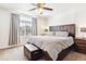 Well-lit main bedroom with large bed, bedside tables, and a neutral color palette at 20017 E 48Th Pl, Denver, CO 80249