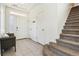 Bright entryway with tile flooring, a coat closet and access to the carpeted stairs to the second floor at 20017 E 48Th Pl, Denver, CO 80249