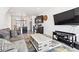 Open-concept living room featuring modern furniture, large windows, and plenty of natural light at 20017 E 48Th Pl, Denver, CO 80249