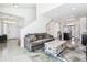 Bright living room featuring neutral walls, plush sofa, and open access to the kitchen and dining area at 20017 E 48Th Pl, Denver, CO 80249