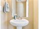 Charming powder room features a pedestal sink with modern fixtures and a neutral color palette at 20017 E 48Th Pl, Denver, CO 80249