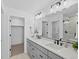 Bathroom with double sinks, gray cabinets, white countertop, and glass shower door at 2078 S Holly St # 3, Denver, CO 80222