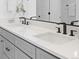 Bathroom featuring a double vanity, black hardware, white quartz countertops, and clean contemporary design at 2078 S Holly St # 3, Denver, CO 80222
