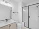 Full bathroom featuring a walk-in shower, modern vanity sink, and contemporary fixtures at 2078 S Holly St # 3, Denver, CO 80222