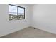 An empty room with a view from the window and carpeted floors provides a blank canvas ready for personalization at 2078 S Holly St # 3, Denver, CO 80222