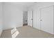 Bedroom featuring carpeted flooring, a double closet, and a view into the hallway at 2078 S Holly St # 3, Denver, CO 80222