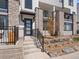 Welcoming townhome entrance with stone details, modern door, and landscaped garden area leading to the front steps at 2078 S Holly St # 3, Denver, CO 80222