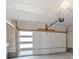 Spacious garage featuring a modern door with windows, ample lighting, and concrete flooring at 2078 S Holly St # 3, Denver, CO 80222