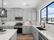 Modern kitchen featuring gray cabinets, quartz countertops, stainless appliances, and a black faucet at 2078 S Holly St # 3, Denver, CO 80222