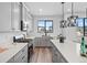 A modern kitchen showcasing sleek gray cabinetry, quartz countertops, and stainless steel appliances at 2078 S Holly St # 3, Denver, CO 80222
