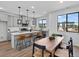Bright, open kitchen featuring an island with seating, pendant lighting and stainless steel appliances at 2078 S Holly St # 3, Denver, CO 80222