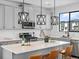 Stylish kitchen boasts gray cabinets, quartz countertops, stainless appliances, and modern pendant lighting at 2078 S Holly St # 3, Denver, CO 80222