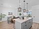 Kitchen with an island featuring pendant lighting, quartz countertops and stainless appliances at 2078 S Holly St # 3, Denver, CO 80222