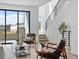Living room with modern decor, wood floors, sliding doors to a patio, and staircase at 2078 S Holly St # 3, Denver, CO 80222