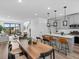 Open-concept floor plan featuring a kitchen island, dining table and living room at 2078 S Holly St # 3, Denver, CO 80222