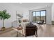 Bright living room with a neutral color scheme, modern furnishings, and an adjacent balcony at 2078 S Holly St # 3, Denver, CO 80222