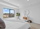 Bright main bedroom with a large window, tray ceiling, light walls, and carpeted floor at 2078 S Holly St # 3, Denver, CO 80222