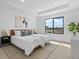 Bright main bedroom with large window, tray ceiling, neutral colors, and carpeted floor at 2078 S Holly St # 3, Denver, CO 80222
