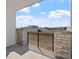 Private patio with stone accents and metal railing offers an outdoor relaxation space with neighborhood views at 2078 S Holly St # 3, Denver, CO 80222