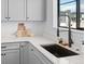 Kitchen sink featuring quartz countertops, stainless steel appliances, and modern faucet at 2078 S Holly St # 3, Denver, CO 80222