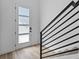 Inviting entryway with a modern front door and staircase featuring wood floors and sleek metal railings at 2078 S Holly St # 3, Denver, CO 80222