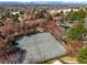 Aerial view of the community tennis court near the neighborhood pool and clubhouse, surrounded by mature trees at 1842 S Pitkin Cir # A, Aurora, CO 80017