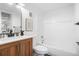 This updated bathroom features modern fixtures, a wood vanity, framed mirror, and shower at 1842 S Pitkin Cir # A, Aurora, CO 80017
