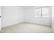 This bedroom features neutral carpeting, a large window, and light colored walls at 1842 S Pitkin Cir # A, Aurora, CO 80017