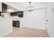 Open dining area with dark cabinets, modern lighting, and easy access to kitchenette at 1842 S Pitkin Cir # A, Aurora, CO 80017
