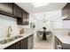 This updated kitchen features stainless appliances, dark cabinets with gold hardware, and a dining area at 1842 S Pitkin Cir # A, Aurora, CO 80017