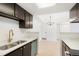 This updated kitchen features stainless appliances, dark cabinets with gold hardware, and stylish fixtures at 1842 S Pitkin Cir # A, Aurora, CO 80017