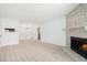 Spacious living room with stone fireplace, light wood floors, and open layout at 1842 S Pitkin Cir # A, Aurora, CO 80017