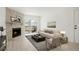 Staged living room featuring a stone fireplace, balcony access, and stylish decor at 1842 S Pitkin Cir # A, Aurora, CO 80017