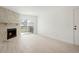 Bright living room with stone fireplace, sliding glass door to balcony, and neutral flooring at 1842 S Pitkin Cir # A, Aurora, CO 80017